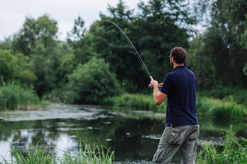 close-up-man-fishing-lake_23-2147870144